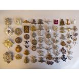 Approx. fifty military cap badges and other insignia, some copies: to include Bombay Jail