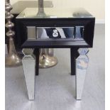A modern black and clear mirrored single drawer bedside table, raised on tapered legs  29"h  14"w