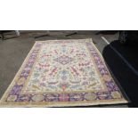 A Persian design carpet, decorated with floral motifs, on a beige ground  130" x 98"