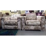 A pair of modern two tone silver crushed velvet effect upholstered, enclosed armchairs, on steel