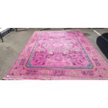 An Oriental design carpet, decorated with birds of paradise, on a bright pink ground  108" x 140"