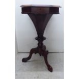 A late Victorian mahogany and rosewood sewing table, the hinged, octagonal chequerboard top on a