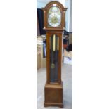 A Canham of London mahogany and figured walnut cased grandmother clock with a round arch hood, flank