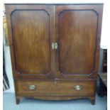 A mid Victorian mahogany one-piece linen press with a pair of doors, enclosing three shelves, over a