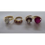 Four dissimilar Victorian and other style gold rings, each set with coloured stones, one with