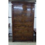 A mid Victorian flame mahogany cupboard, fashioned as a facsimile six drawer tallboy,