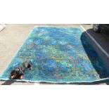A Persian design carpet, decorated with stylised wave motifs, on a blue ground  140" x 106"