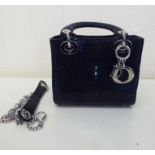 A designer snakeskin effect and stitched black hide evening bag