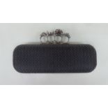 An Alexander McQueen knuckle clutch bag