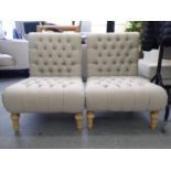 A pair of modern part button grey fabric upholstered bedroom chairs, raised on turned forelegs