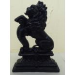 A Victorian style black painted cast iron door porter, fashioned as a rampant lion  14"h