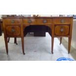 An Edwardian Sheraton Revival string and ebony inlaid mahogany breakfront, one-piece, five drawer