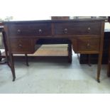 An early 20thC mahogany five drawer kneehole desk, raised on square tapered legs and casters  30"