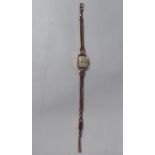 A lady's Tudor 9ct gold cased and strapped wristwatch, faced by a ball and baton dial