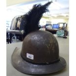 A soldiers re-enactment helmet with black feather plume