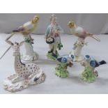 Six early 20thC porcelain figures: to include a seated Worcester giraffe  4.5"h; and a young man