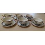 A set of six Japanese Satsuma earthenware teacups and saucers, decorated with bamboo