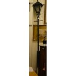 A black painted iron street lamp with a lantern shade  100"h
