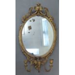 A 19thC oval girandole, set in an elaborately moulded gilt gesso frame, incorporating three