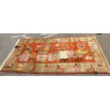 A Chinese rug, decorated with a Khitan vase design, on an orange and cream coloured ground  100" x