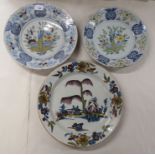 Three 19thC Continental tin glazed earthenware chargers, decorated with flora  largest 13"dia