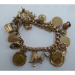 A 9ct gold charm bracelet with 9ct gold and yellow metal charms: to include a sovereign  1906; and a