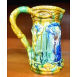 A majolica jug, decorated in colours with dancing figures  9.5"h