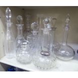 Ten various crystal and other glass decanters: to include a late 19thC example of tapered, bottle