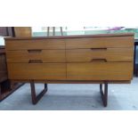 A 1960s Unflex teak six drawer dressing chest, raised on splayed legs  28"h  47"w