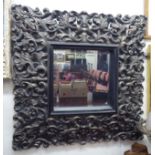 A modern mirror, the bevelled plate set in an antique finished frame  37" x 37"