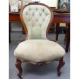 A late Victorian mahogany showwood framed nursing chair, part button upholstered in silvered fabric,