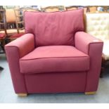 A modern red fabric upholstered enclosed armchair