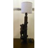 A 20thC Black Forest carved limewood table lamp, in the form of a bear climbing a tree  18"h