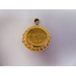 A 9ct gold engraved circular locket, on a pendant ring