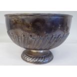 An Edwardian silver punch bowl of traditional pedestal design with embossed demi-reeded and stop-