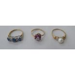 Three 9ct gold dress rings, one set with aquamarines and diamonds; the second, set with a pearl,