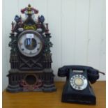 An early 20thC American mantel timepiece  17"h; and a later telephone with a rotating dial, in a