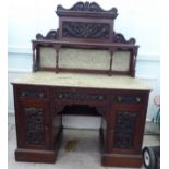 A late Victorian carved mahogany and marble two piece washstand with three frieze drawers, over an