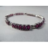 A 9ct white gold, multi-link bracelet, set with thirty-five rubies