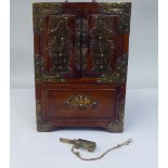 A 20thC Japanese hardwood table cabinet with engraved brass fittings and mounts, comprising a pair