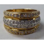 A 14ct gold, four row diamond, wide set band ring