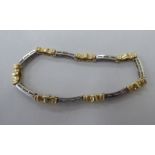 A 14ct white and yellow gold bracelet, set with sapphires and diamonds