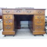 A late 19thC mahogany and oak nine drawer twin pedestal desk, on a plinth  28"h  50"w