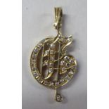 A 14ct gold and diamond set pendant, fashioned as a musical note
