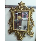 An early 20thC mirror, the bevelled plate set in a carved gilt frame  25" x 18"