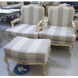 A pair of modern French style showwood framed open arm chairs, upholstered in white and grey fabric;