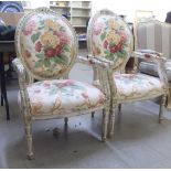 A pair of modern French style open arm chairs, upholstered in floral fabric