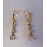 A pair of 9ct gold three stone drop earrings