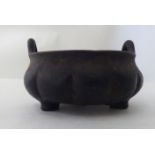 A Chinese bronze censer with opposing loop handles  bears a six character mark  3.5"dia
