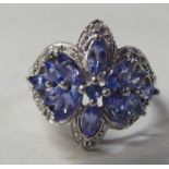 A silver coloured metal and tanzanite set ring
